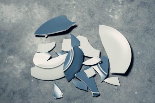Broken plate against a grey background